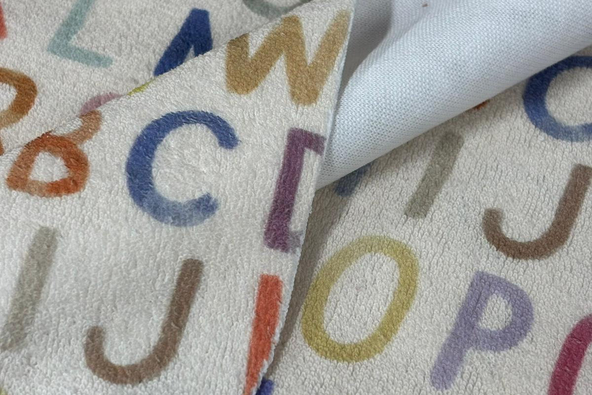 Fabric with colorful letters on a plain background