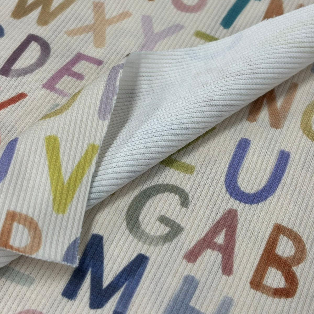 Textile with colorful letters on a white background