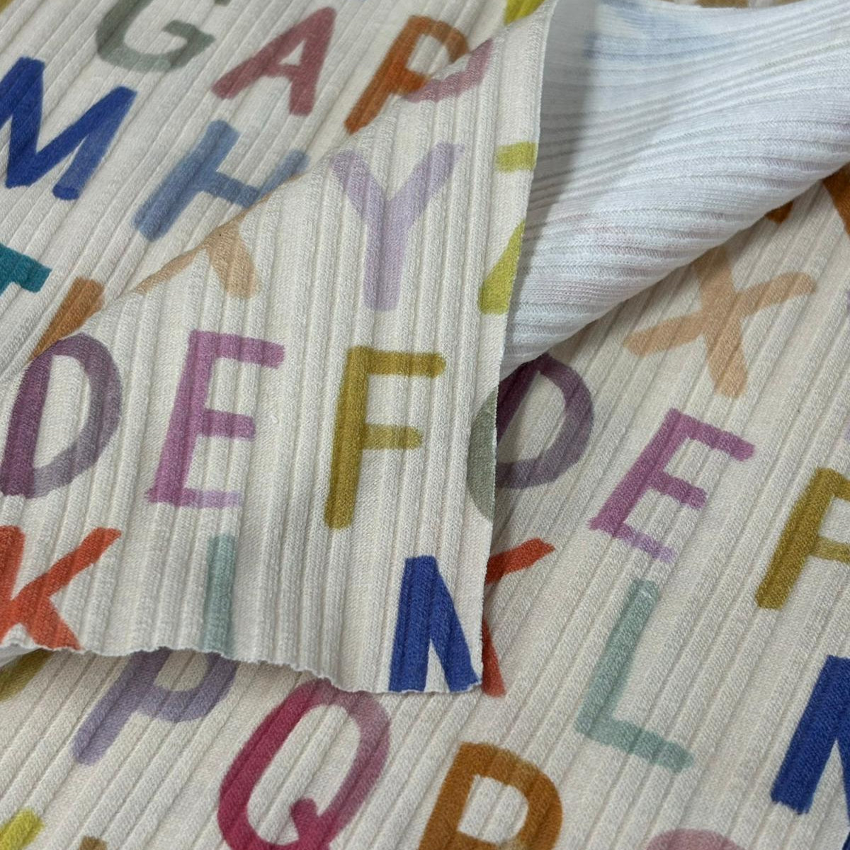 Textile with colorful letters on a white background